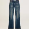 Pantalones de mezclilla de corte acampanado para mujer con lavado vintage y detalles metálicos