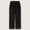 Pantalones de mujer en denim de algodón negro con acabado desgastado