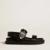 Sandalia Lucy para mujer en cuero negro brillante con hebilla de metal dorado