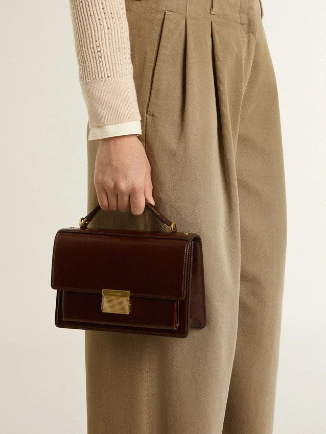 Bolso Venezia en cuero laminado color marrón oscuro con detalles dorados
