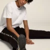 Camiseta blanca para mujer con logotipo plateado con purpurina y estrella