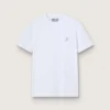 Camiseta blanca para mujer con una estrella plateada con purpurina en el frente