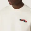 Camiseta unisex de la colección Resort, de algodón blanco con estampado y logotipo