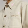 Chaqueta beige para niños con salpicaduras multicolores