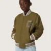 Chaqueta bomber unisex Journey en sarga de nailon verde militar con parche bordado