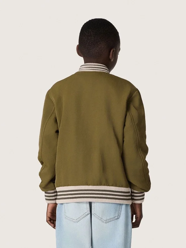 Chaqueta bomber unisex Journey en sarga de nailon verde militar con parche bordado