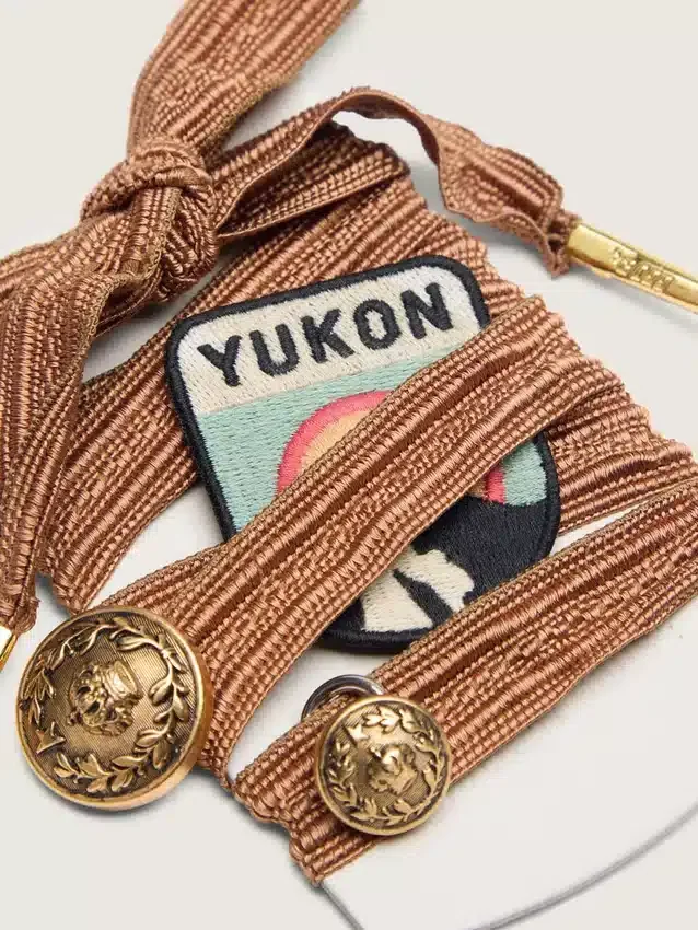 Cordones bordados «Pieles» en color burdeos y melocotón con parche y dos dijes