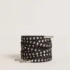 Cordones de algodón negro con estrellas plateadas en contraste