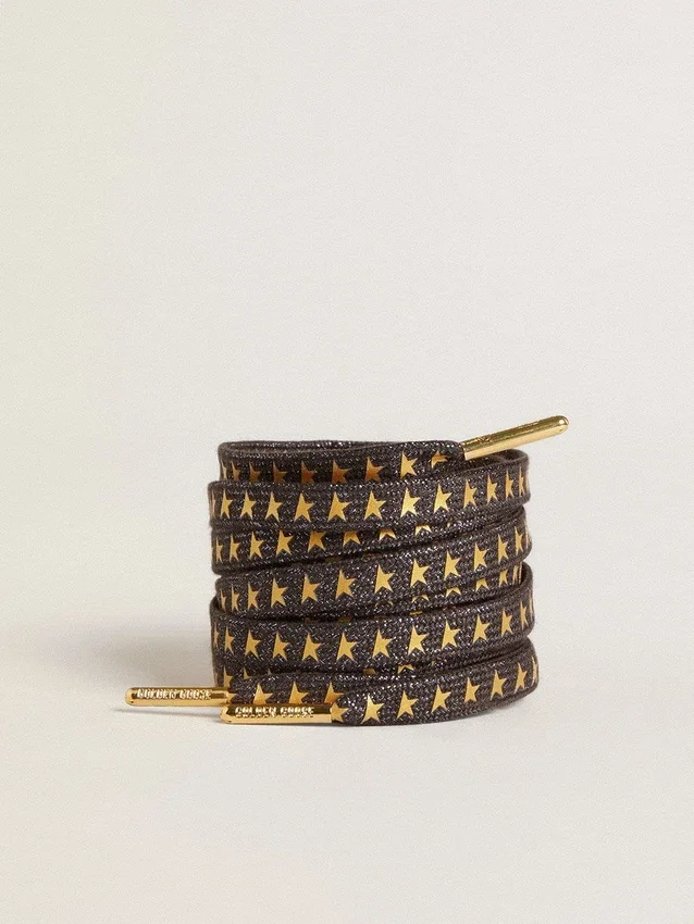 Cordones de lurex gris oscuro con estrellas doradas en contraste