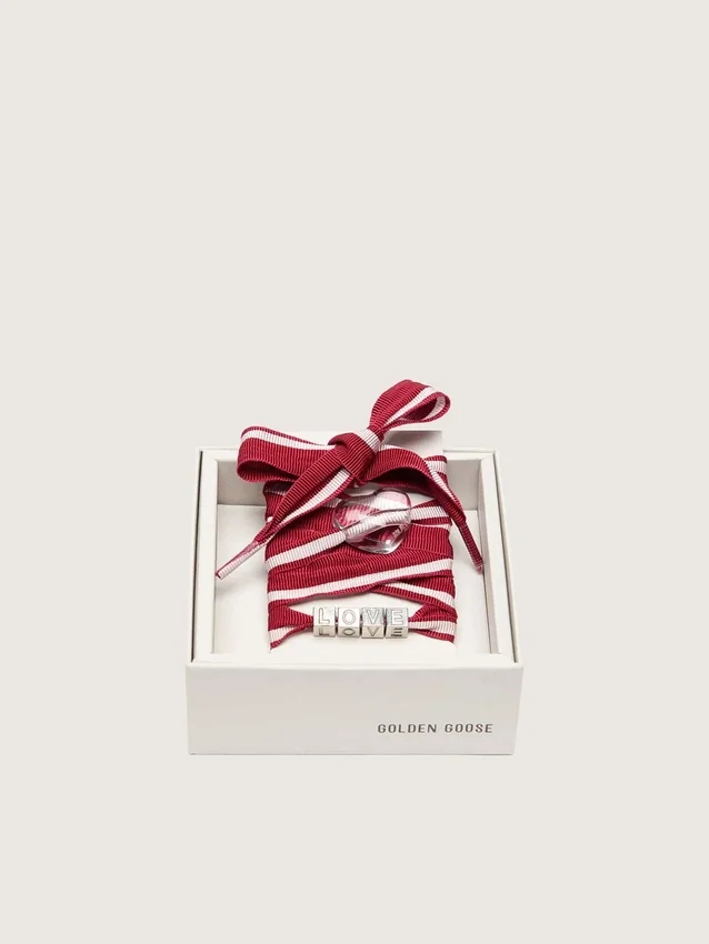 Cordones «Pieles» a rayas rojas y blancas con dijes