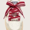 Cordones «Pieles» a rayas rojas y blancas con dijes