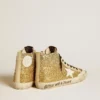 Francy Penstar en brillo dorado con estrella de cuero blanco