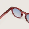 Gafas de sol Cameron Panthos con montura color miel, piedras preciosas y lentes azules