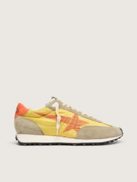Marathon para mujer con parte superior de nylon amarillo y estrella naranja