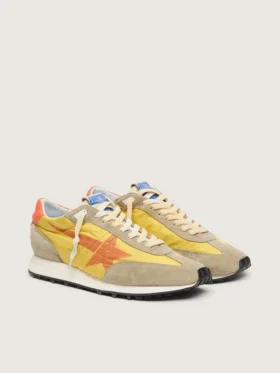 Marathon para mujer con parte superior de nylon amarillo y estrella naranja