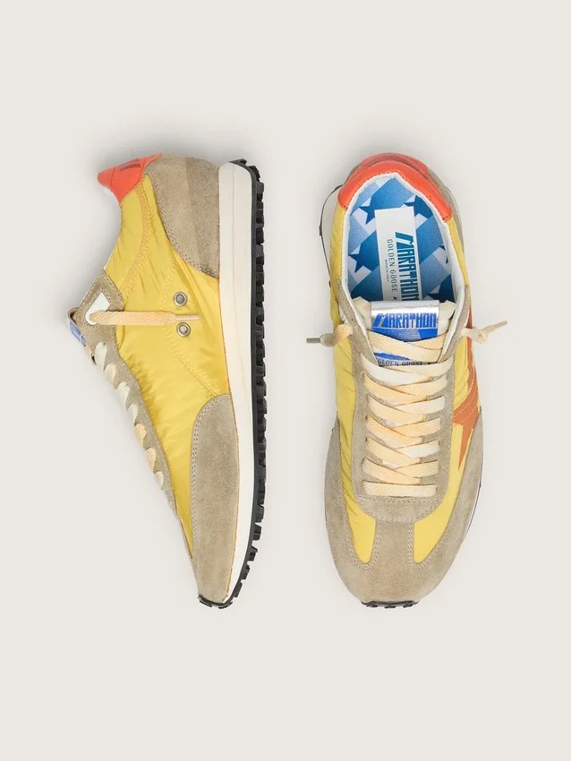Marathon para mujer con parte superior de nylon amarillo y estrella naranja