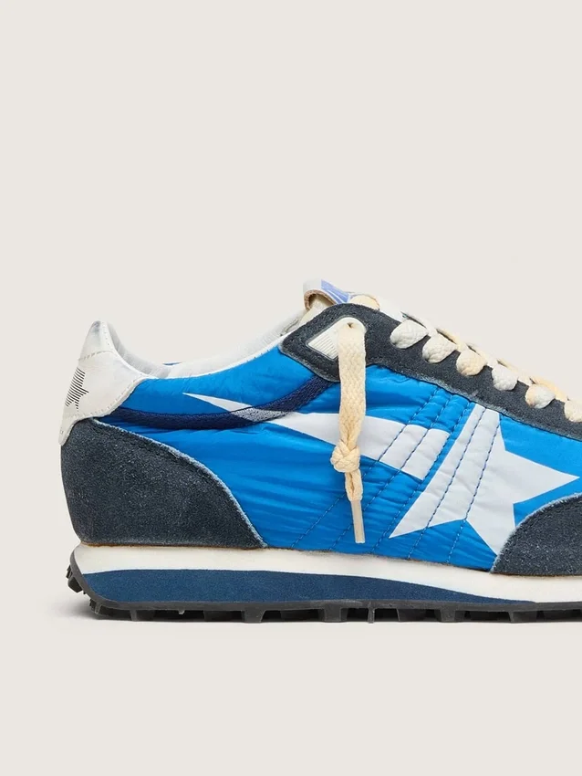 Marathon para mujer con parte superior de nylon azul y estrella blanca