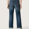 Pantalones de mezclilla para niños con bordes sin rematar y bordado