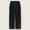 Pantalones de mujer en denim de algodón negro con acabado desgastado