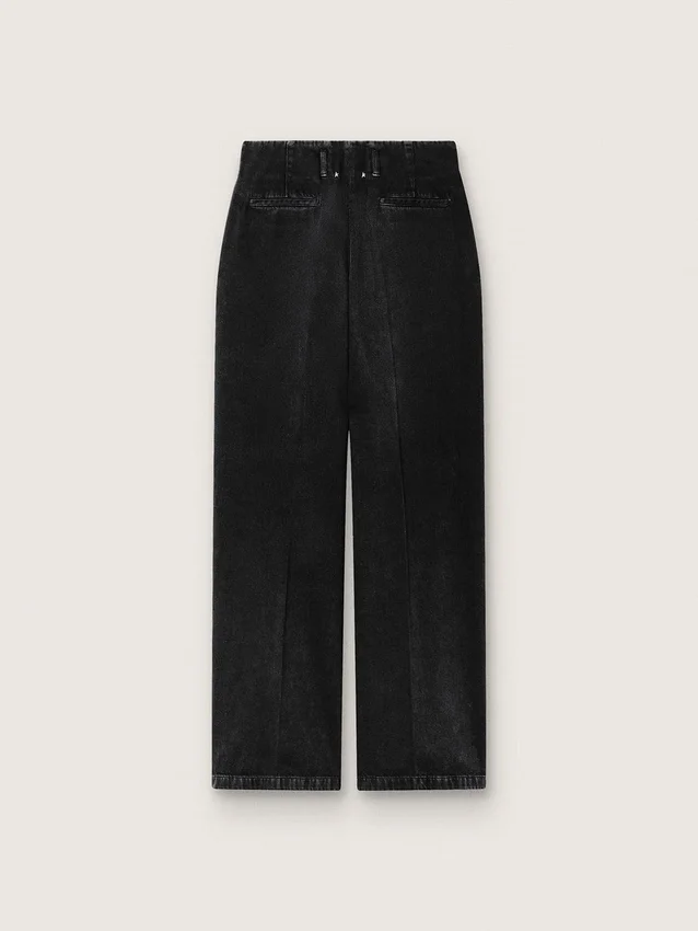 Pantalones de mujer en denim de algodón negro con acabado desgastado