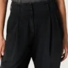 Pantalones de mujer en denim de algodón negro con acabado desgastado