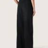 Pantalones de mujer en denim de algodón negro con acabado desgastado