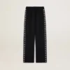 Pantalones joggers negros para mujer con estrellas blancas en los costados