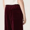 Pantalones para niñas de color burdeos con efecto terciopelo y bolsillo trasero