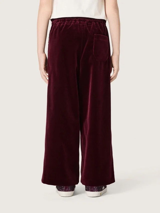 Pantalones para niñas de color burdeos con efecto terciopelo y bolsillo trasero
