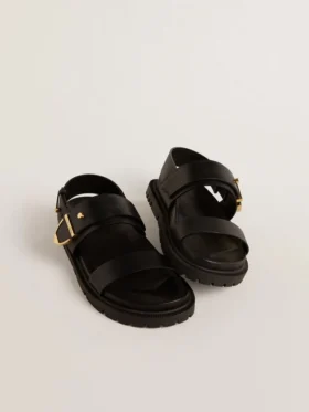 Sandalia Lucy para mujer en cuero negro brillante con hebilla de metal dorado