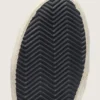 Slide para mujer en negro y purpurina plateada con estrella de cuero y detalles metálicos