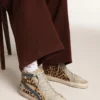 Slide para mujer en piel de potro con estampado de leopardo y estrella de cuero plateada