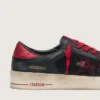 Stardan para hombre en cuero negro con estrella roja e inserciones de malla negra y cuero rojo