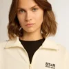 Sudadera blanca con cremallera para mujer, con franja blanca y estrellas negras
