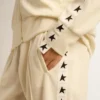 Sudadera blanca con cremallera para mujer, con franja blanca y estrellas negras