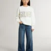 Sudadera blanca para niñas con letras doradas multicolores en el frente
