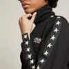 Sudadera negra con cremallera para mujer con estrellas blancas