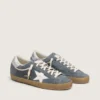 Super-Star para hombre en gamuza gris con estrella de cuero blanco y lengüeta de talón de cuero plateado