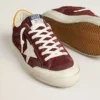 Super-Star para hombre en gamuza rojo ladrillo con estrella de cuero blanco y lengüeta en el talón con estampado animal