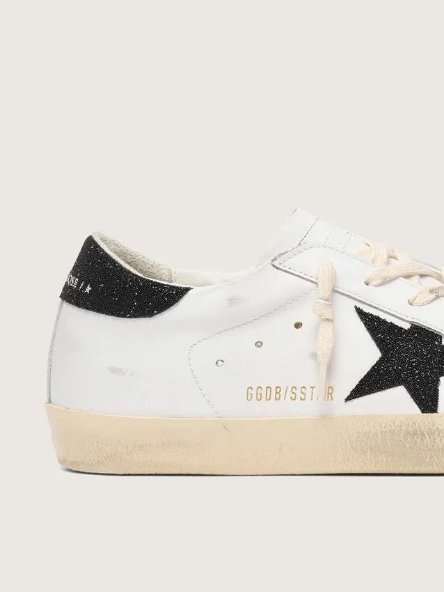 Super-Star para mujer con una estrella de cristales Swarovski negros y lengüeta en el talón