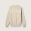 Suéter unisex de cuello redondo en algodón beige con parche en el frente y logotipo en la espalda