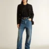 Top de malla negra con lentejuelas y detalles en contraste