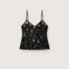 Top de mujer de tul negro con estampado floral de lentejuelas negras