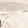 Zapatillas Purestar para mujer con lengüeta en el talón de color dorado