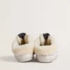 Zapatos tipo Super-Star Sabot en cuero blanco con forro de piel de oveja y estrella plateada